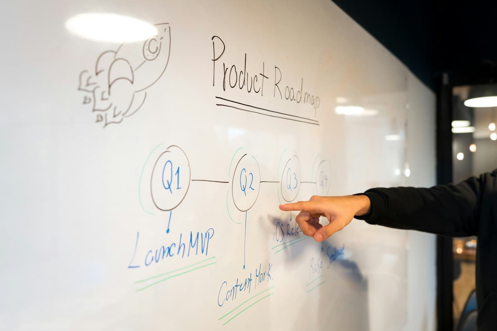 Engineer sketching a system diagram on a whiteboard