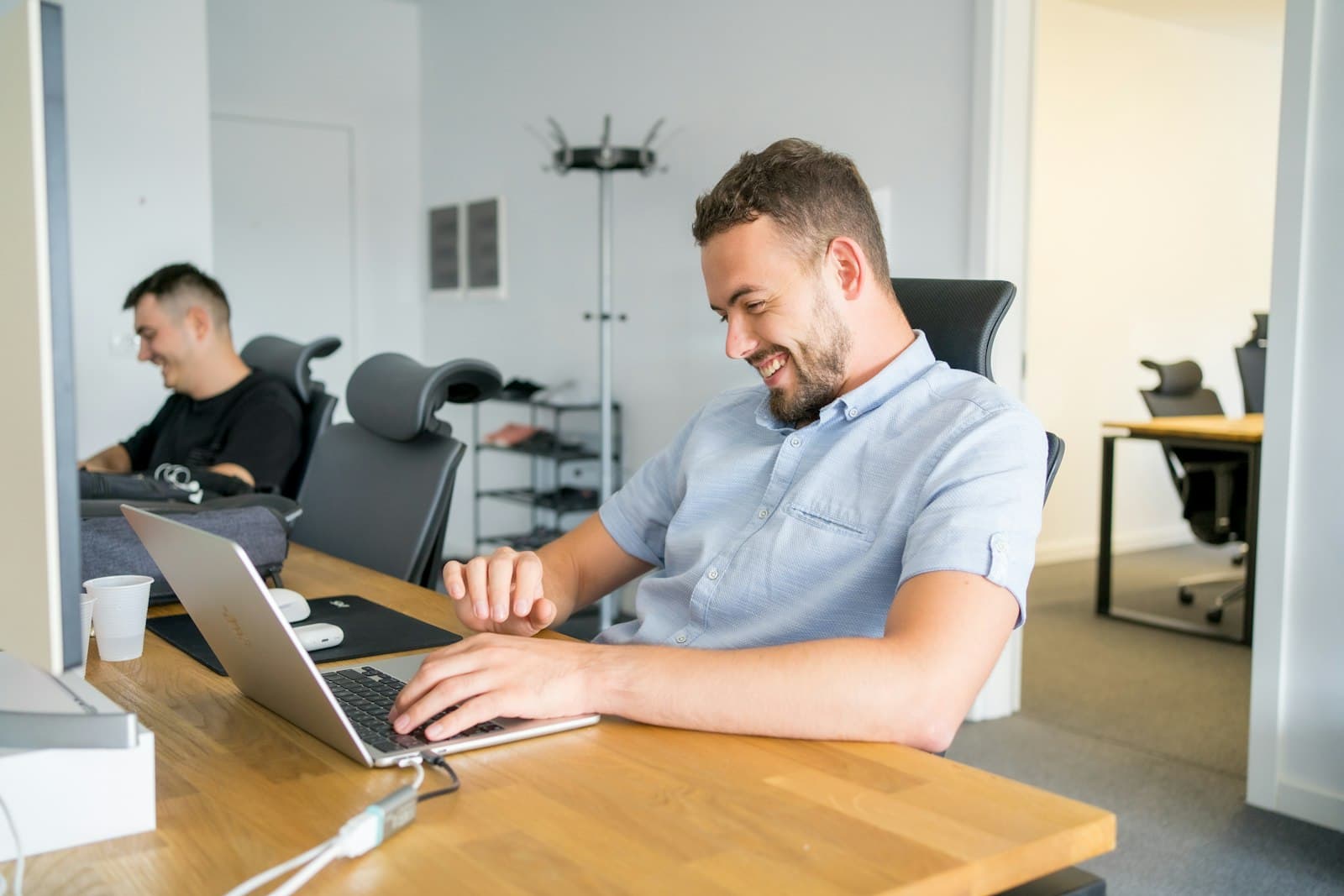 Developer working on a laptop in a bright office